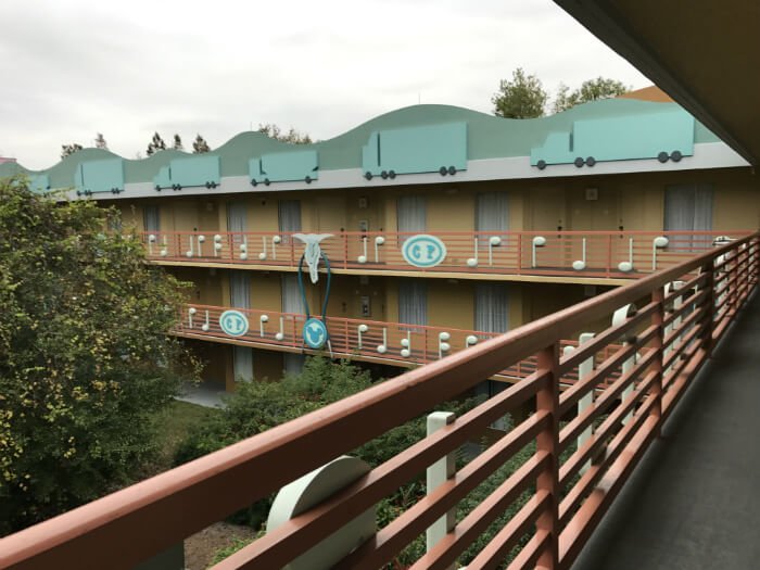 All Star Music resort exterior with musical instruments and Mickey Mouse ears on balcony railing