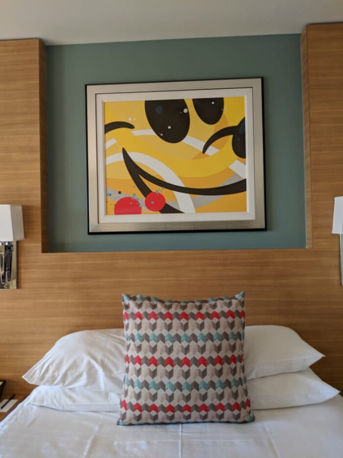 bed and Mickey Mouse painting in Bay Lake Tower villa