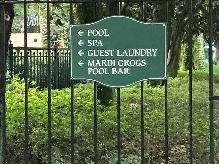 Port Orleans French Quarter sign for pool, spa, guest laundry, Mardi Gras pool bar