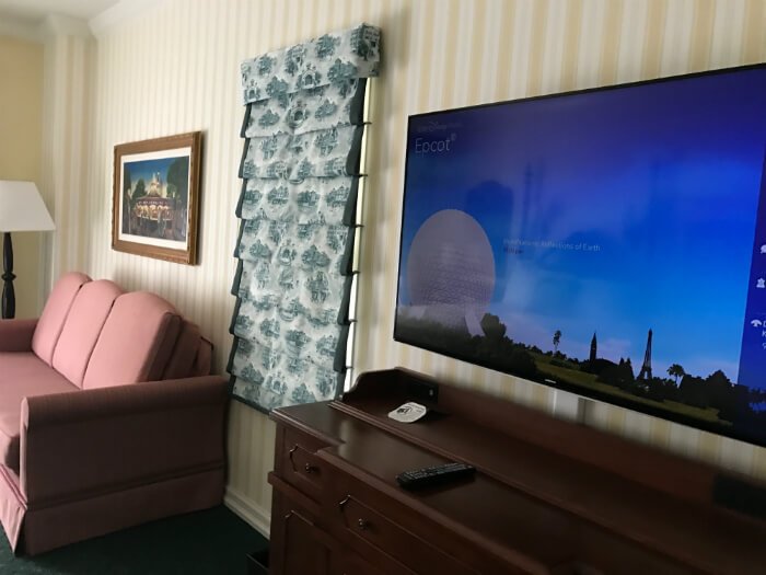 Gigantic television & comfortable sofa will make your stay at Disney's Boardwalk Inn wonderful