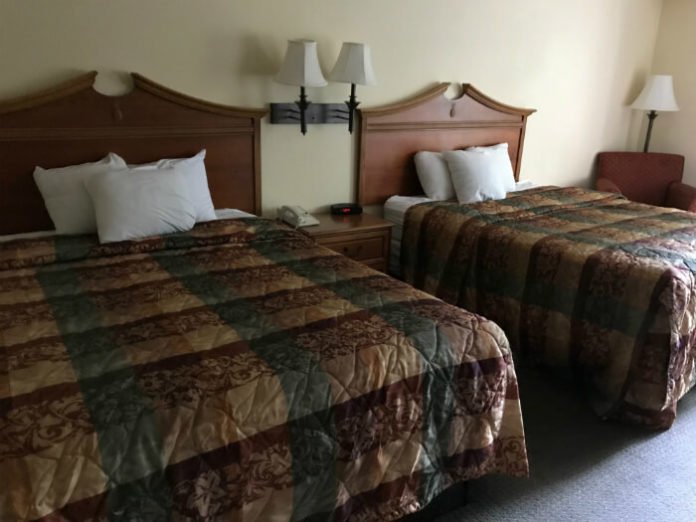 beds, chair, lamp inside Country Inn & Suites Williamsburg hotel room