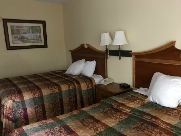 Country Inn & Suites Williamsburg hotel room with beds, picture on wall, nightstand