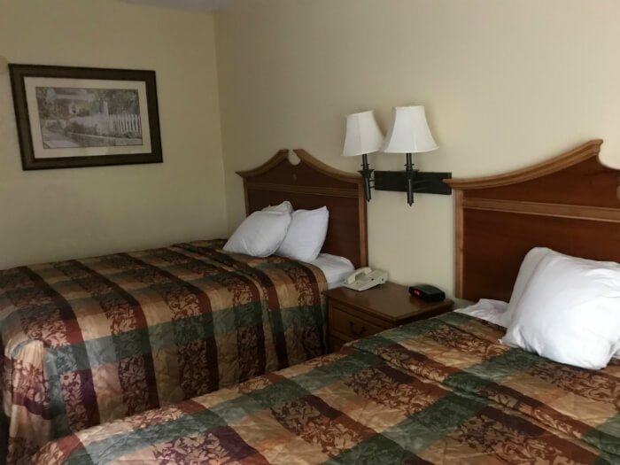 Country Inn & Suites Williamsburg hotel room with beds, picture on wall, nightstand