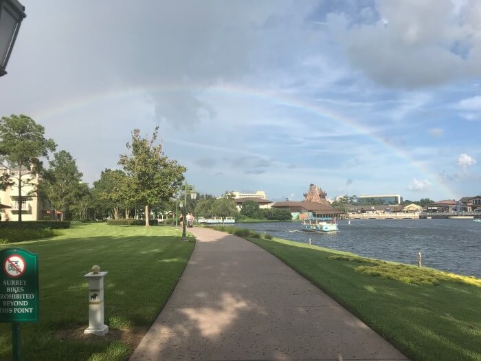 walkway to Disney Springs at Saratoga Springs hotel with rainbow in sky