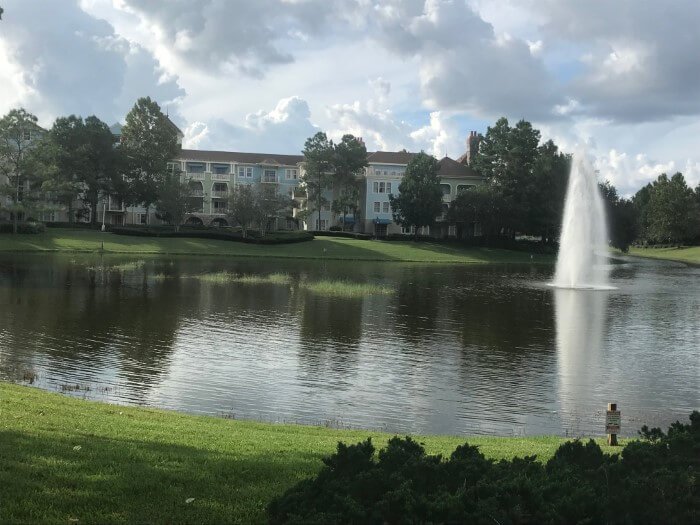 Saratoga Springs hotel building exterior, lake & fountain at daytime