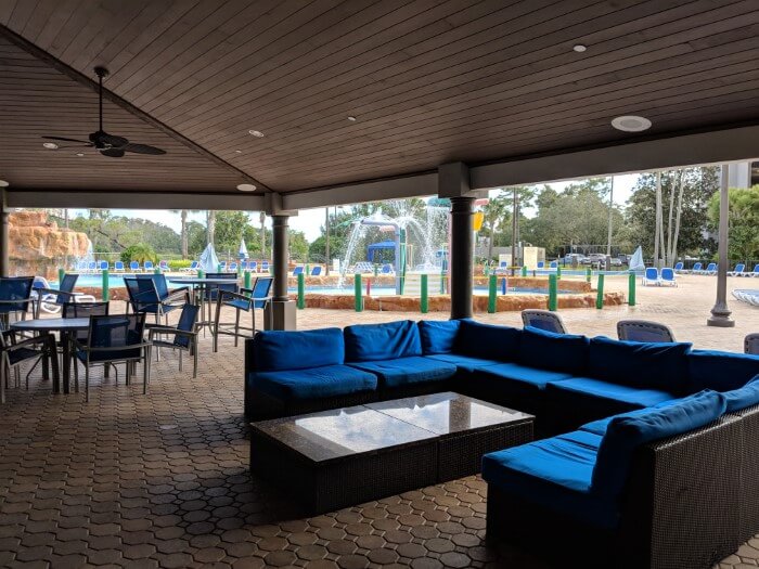 Comfortable seats & tables near pool at Wyndham Disney Springs