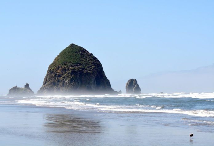 Picture of Haystack rock in Cannon Beach, Oregon. Find out the areas best luxury resorts & how to get a good deal for them.