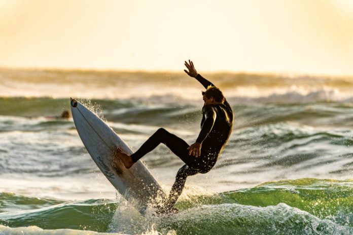 Picture of a man surfing in Pacific Grove, California. Read our travel tips on how to get a good price on the best Pacific Grove hotels