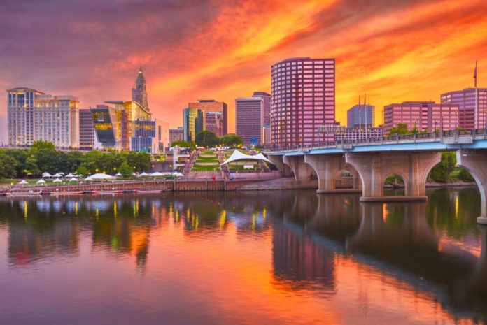 Hartford, Connecticut, USA downtown skyline on the river at dusk. Find out what the best luxury hotels there are