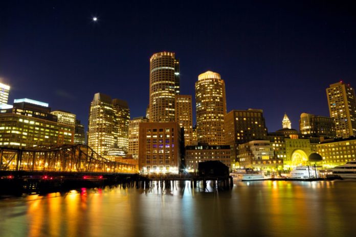 Nighttime view of Boston Harbor, Massachusetts, USA. Find out how to save on a 4th of July weekend cruise there